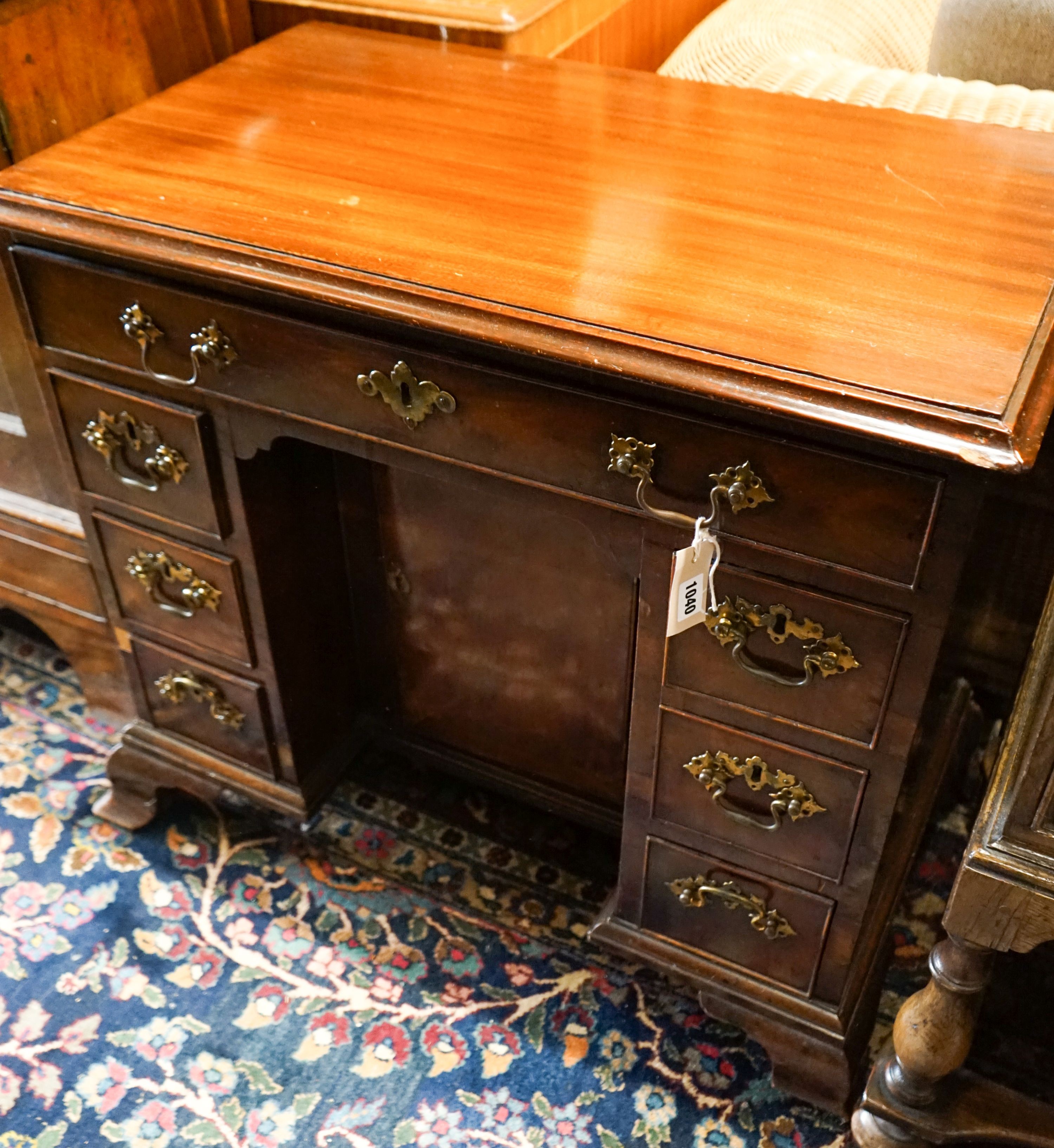 A George III and later mahogany kneehole desk, fitted seven drawers and recessed cupboard on ogee bracket feet, width 81cm, depth 47cm, height 71cm